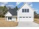 Beautiful new construction home featuring a three-car garage, crisp white siding, and a welcoming wood door at 2095 Tite Rd, Stanfield, NC 28163