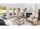 Bright living room featuring a modern fireplace, sleek furnishings, and light hardwood floors at 2095 Tite Rd, Stanfield, NC 28163