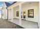 Covered patio featuring white columns, sleek black trim, and ample natural light at 2095 Tite Rd, Stanfield, NC 28163