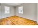 Bright bedroom with hardwood floors, two windows and neutral paint at 2123 Purser Dr, Charlotte, NC 28215