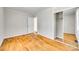Bedroom with wood floors, closet, and white trim at 2123 Purser Dr, Charlotte, NC 28215