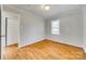 Cozy bedroom with hardwood floors, neutral walls, and closet at 2123 Purser Dr, Charlotte, NC 28215