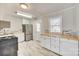 Updated kitchen with stainless steel appliances, ample white cabinets, and butcher block countertops at 2123 Purser Dr, Charlotte, NC 28215