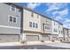 Row of townhomes showcasing multiple garage doors and siding, with bright blue sky backdrop at 234 Iverson Way, Charlotte, NC 28203