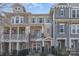 Charming townhome with a combination of stone and siding and a lovely fenced front yard at 234 Iverson Way, Charlotte, NC 28203
