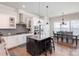 Bright kitchen featuring stainless appliances, granite counters, and dark island with barstool seating at 234 Iverson Way, Charlotte, NC 28203