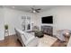This living room features a ceiling fan, plush seating, and access to a balcony for fresh air at 234 Iverson Way, Charlotte, NC 28203