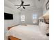 Bright main bedroom features tray ceiling, a ceiling fan, and windows on two walls at 234 Iverson Way, Charlotte, NC 28203