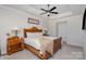 Main bedroom suite features tray ceiling, a ceiling fan, and bedside tables with lamps at 234 Iverson Way, Charlotte, NC 28203