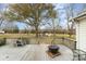 Spacious back deck with rustic fire pit and tranquil views, perfect for outdoor entertaining and relaxation at 24697 Ramsey Dr, Albemarle, NC 28001
