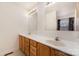 Bright bathroom featuring double sinks, ample counter space, and a large mirror for a functional and stylish design at 24697 Ramsey Dr, Albemarle, NC 28001