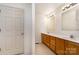 Bathroom featuring a double sink vanity with wood cabinetry and neutral walls at 24697 Ramsey Dr, Albemarle, NC 28001