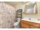This bathroom features a seashell-themed shower curtain adding charm and personality to the space at 24697 Ramsey Dr, Albemarle, NC 28001