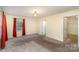 Inviting bedroom featuring neutral carpet, natural light, and easy access to a walk-in closet at 24697 Ramsey Dr, Albemarle, NC 28001