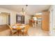 Eat-in kitchen and dining area, complete with wood flooring, island seating, and a charming chandelier at 24697 Ramsey Dr, Albemarle, NC 28001