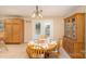 Cozy dining area featuring natural light, a wooden table, and ample storage space, perfect for Gathering meals at 24697 Ramsey Dr, Albemarle, NC 28001