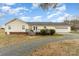 View of back exterior with a deck and attached garage on a large lot at 24697 Ramsey Dr, Albemarle, NC 28001