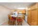Traditional kitchen with bar seating, white appliances, wood cabinets, and tiled flooring at 24697 Ramsey Dr, Albemarle, NC 28001