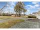Extensive yard featuring a large mature tree, lake access, and multiple outbuildings at 24697 Ramsey Dr, Albemarle, NC 28001