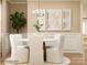 Bright dining room featuring wainscotting, a round table, white chairs, and pendant lighting at 250 Tackle Box Dr, Troutman, NC 28166
