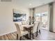 This dining room features modern decor, stylish lighting, and a sliding glass door that lets in natural light at 253 Tackle Box Dr, Troutman, NC 28166