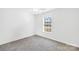 Carpeted bedroom featuring a bright window and neutral colored walls at 2625 Larry Dr, Charlotte, NC 28214