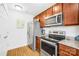 Functional kitchen with stainless steel appliances and wood cabinets and hardware at 2625 Larry Dr, Charlotte, NC 28214