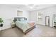 Bright main bedroom features carpet, neutral walls, ceiling fan, and large window at 2625 Larry Dr, Charlotte, NC 28214
