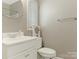 A well-lit half bath featuring a pedestal sink and neutral wall color at 2658 Dilworth Heights Ln, Charlotte, NC 28209