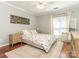 Sunlit bedroom features hardwood floors, patterned bedding, and neutral decor for a cozy retreat at 2658 Dilworth Heights Ln, Charlotte, NC 28209