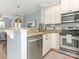 Modern kitchen features stainless steel appliances, granite countertops, and a breakfast bar at 2658 Dilworth Heights Ln, Charlotte, NC 28209