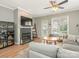 Cozy living room features a fireplace with tile surround, a large TV, and a ceiling fan at 2658 Dilworth Heights Ln, Charlotte, NC 28209