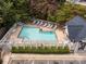 An aerial view of a community pool with lounge chairs and beautiful surrounding landscaping at 2658 Dilworth Heights Ln, Charlotte, NC 28209