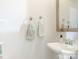 Clean powder room with a pedestal sink, chrome fixtures, and decorative towels at 2658 Dilworth Heights Ln, Charlotte, NC 28209