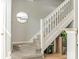 A charming staircase with carpeted steps and white wood railing complemented by a round mirror at 2658 Dilworth Heights Ln, Charlotte, NC 28209