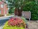 Landscaped entrance to Dilworth Heights with a community sign and seasonal flowers in bloom at 2658 Dilworth Heights Ln, Charlotte, NC 28209