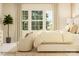 Primary bedroom with a large window and neutral decor, chair and accent table at 2810 Morning Song Way, Lancaster, SC 29720
