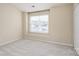 The bedroom boasts natural light with neutral walls, soft carpet, and a double window at 331 Wilkes Place Dr, Fort Mill, SC 29715