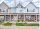Charming brick townhome featuring manicured landscaping and inviting front porches at 331 Wilkes Place Dr, Fort Mill, SC 29715