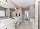 Bright bathroom features double sinks, soaking tub, and tiled floors for a spa-like experience at 4130 Waterway Dr, Monroe, NC 28110
