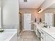 Bright bathroom featuring a soaking tub, a tiled shower, double sink vanity, and neutral color palette at 4130 Waterway Dr, Monroe, NC 28110