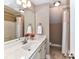 Bathroom featuring vanity with a white countertop, large mirror, and a shower with a curtain at 4130 Waterway Dr, Monroe, NC 28110