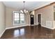 Bright dining room with hardwood floors, modern chandelier, and a view to the front yard at 4130 Waterway Dr, Monroe, NC 28110