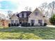 Stunning brick home with dormer windows and lovely landscaping, offering classic curb appeal and a welcoming ambiance at 4130 Waterway Dr, Monroe, NC 28110