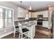 Well-lit kitchen features granite countertops, stainless steel appliances, and eat-in breakfast bar at 4130 Waterway Dr, Monroe, NC 28110