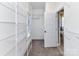 White walk-in closet with metal shelving, neutral carpet and white door at 4130 Waterway Dr, Monroe, NC 28110