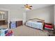 Carpeted bedroom with ceiling fan and adjacent bathroom at 5902 Mt Holly Huntersville Rd, Charlotte, NC 28216