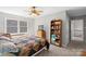 Bedroom showcasing carpet, ceiling fan, and natural light from a window at 5902 Mt Holly Huntersville Rd, Charlotte, NC 28216