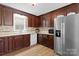 Well-equipped kitchen featuring wood cabinets, stainless steel appliances, and stylish backsplash at 5902 Mt Holly Huntersville Rd, Charlotte, NC 28216