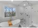 Bright bathroom features a glass shower, and a large window with natural light at 700 Queen Charlottes Ct, Charlotte, NC 28211